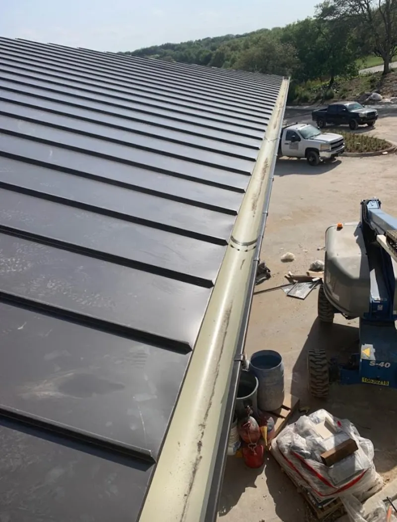 Standing seam panel and gutter detail on a metal roofing jobsite in East Lake
